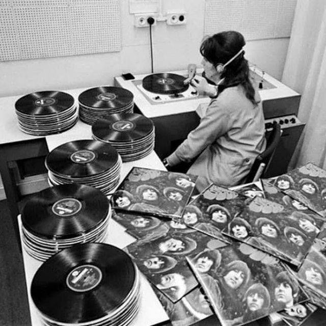 The Beatles lemezeket hallgató nő az EMI gyár minőségellenőrző részlegén az Egyesült Királyságban, 1965-ben.