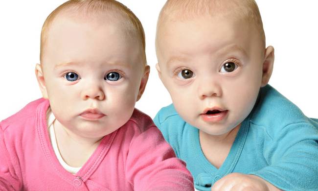 Twin boy and girl on white background
